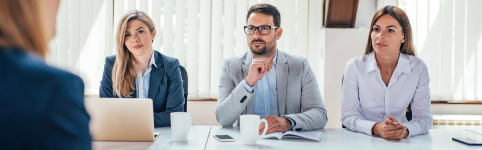 Hr managers interviewing female job applicant.